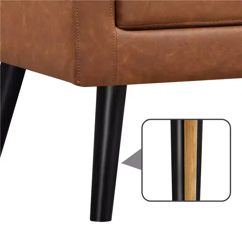 Poltrona moderna in similpelle trapuntata con gambe in legno massello