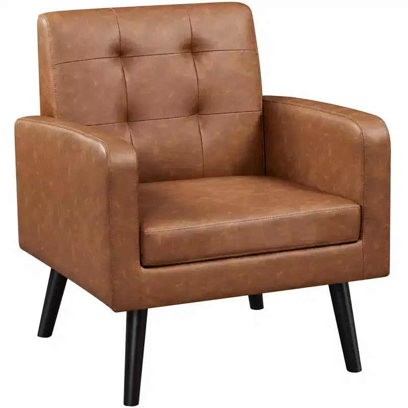 Poltrona moderna in similpelle trapuntata con gambe in legno massello